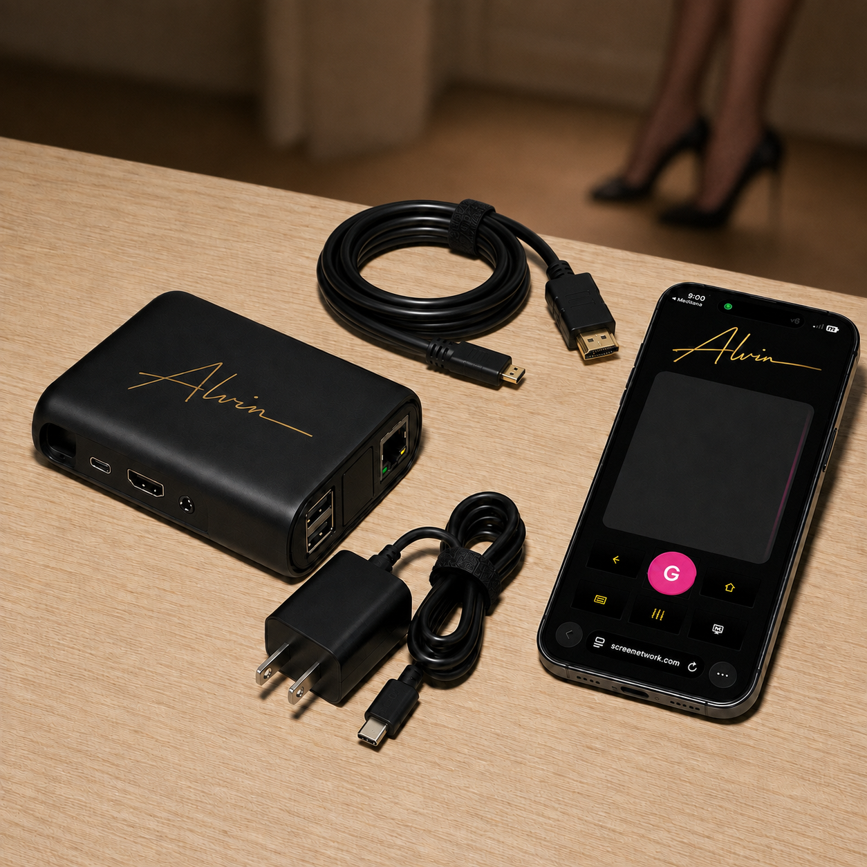 Complete ALVIN package with device, HDMI cable, USB-C power supply, and phone showing the remote app